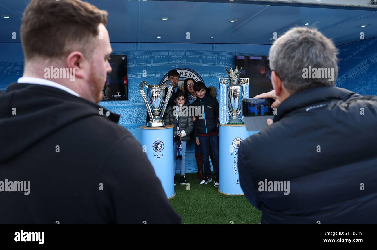 Manchester, UK. 15th January 2022. Fans pose with the MLS Cup and Premier League trophies ahead of the Premier League match at the Etihad Stadium, Manchester. Picture credit should read: Darren Staples / Sportimage Credit: Sportimage/Alamy Live News Stock Photo