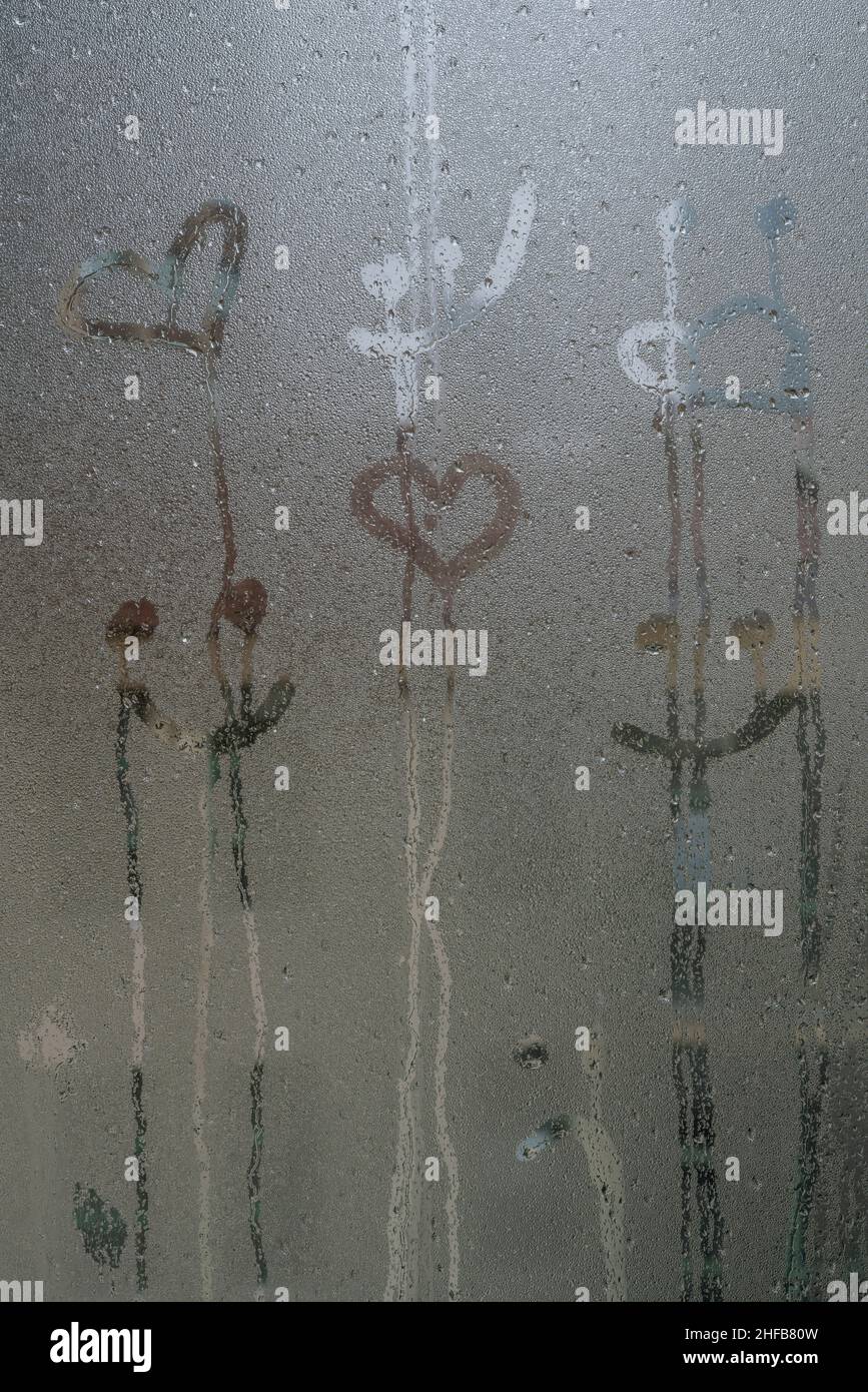 steamed glass, hand drawn smiling face and heart shapes on steamed