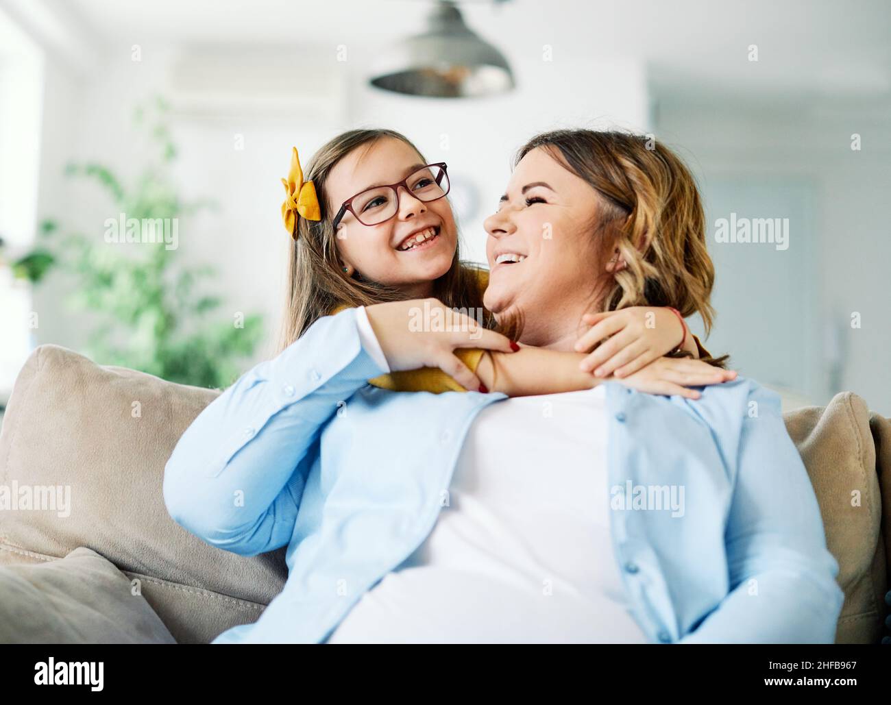 child mother family love parent home woman happy smiling playing kid together childhood girl mom daughter Stock Photo