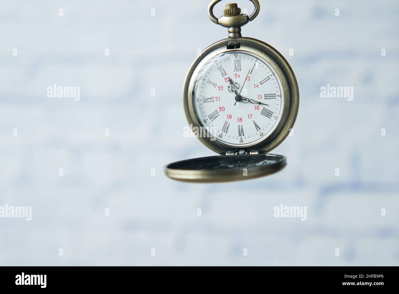 old vintage clock against while wall  Stock Photo