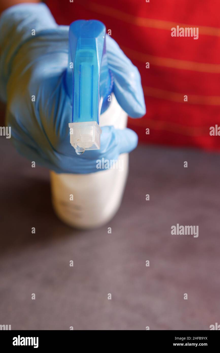 using disinfectant spray to clean table surface Stock Photo - Alamy
