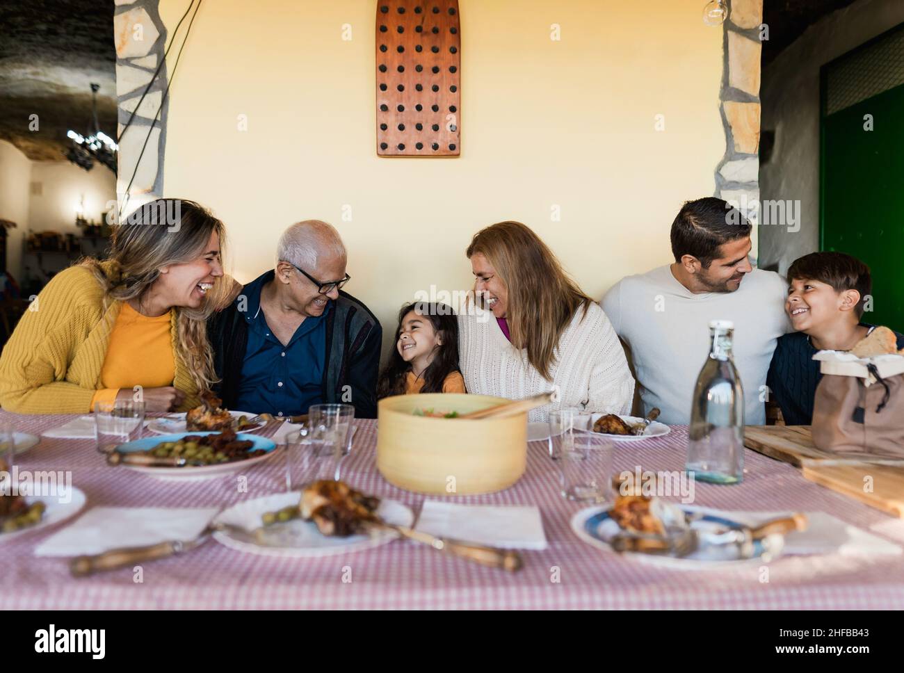 Happy Latin family having fun lunching together at home Stock Photo