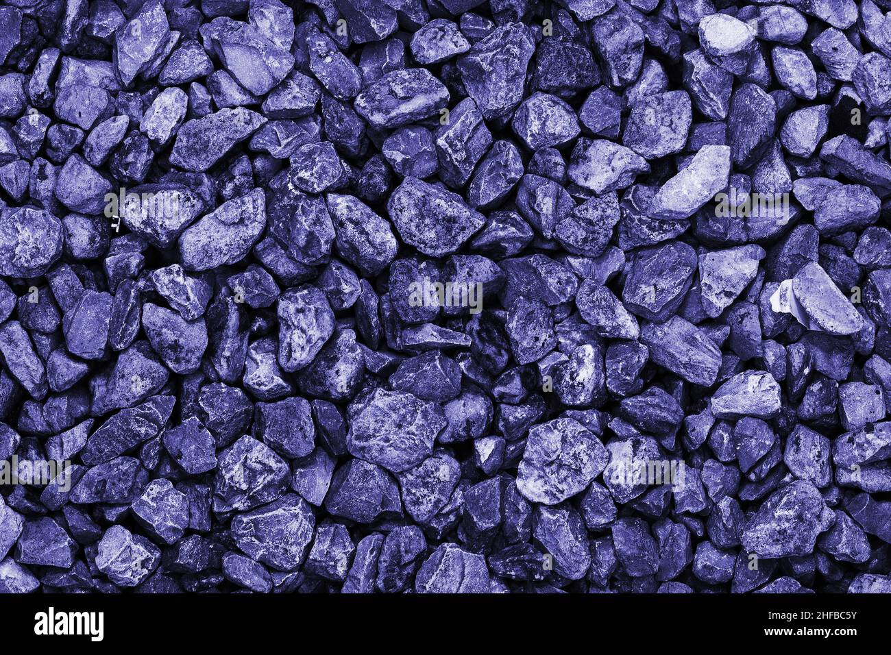 Lots of wet rocks. Pebble background. Lots of purple gems. Modern luxury background or layout with space for text. Color 2022 is very peri year. Stock Photo