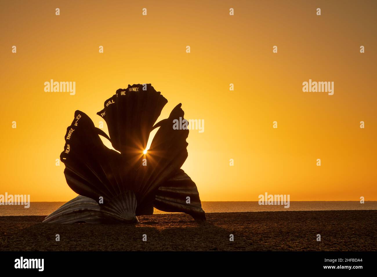 Sunrise at the Scallop sculpture on the beach in Aldeburgh. UK. Stock Photo