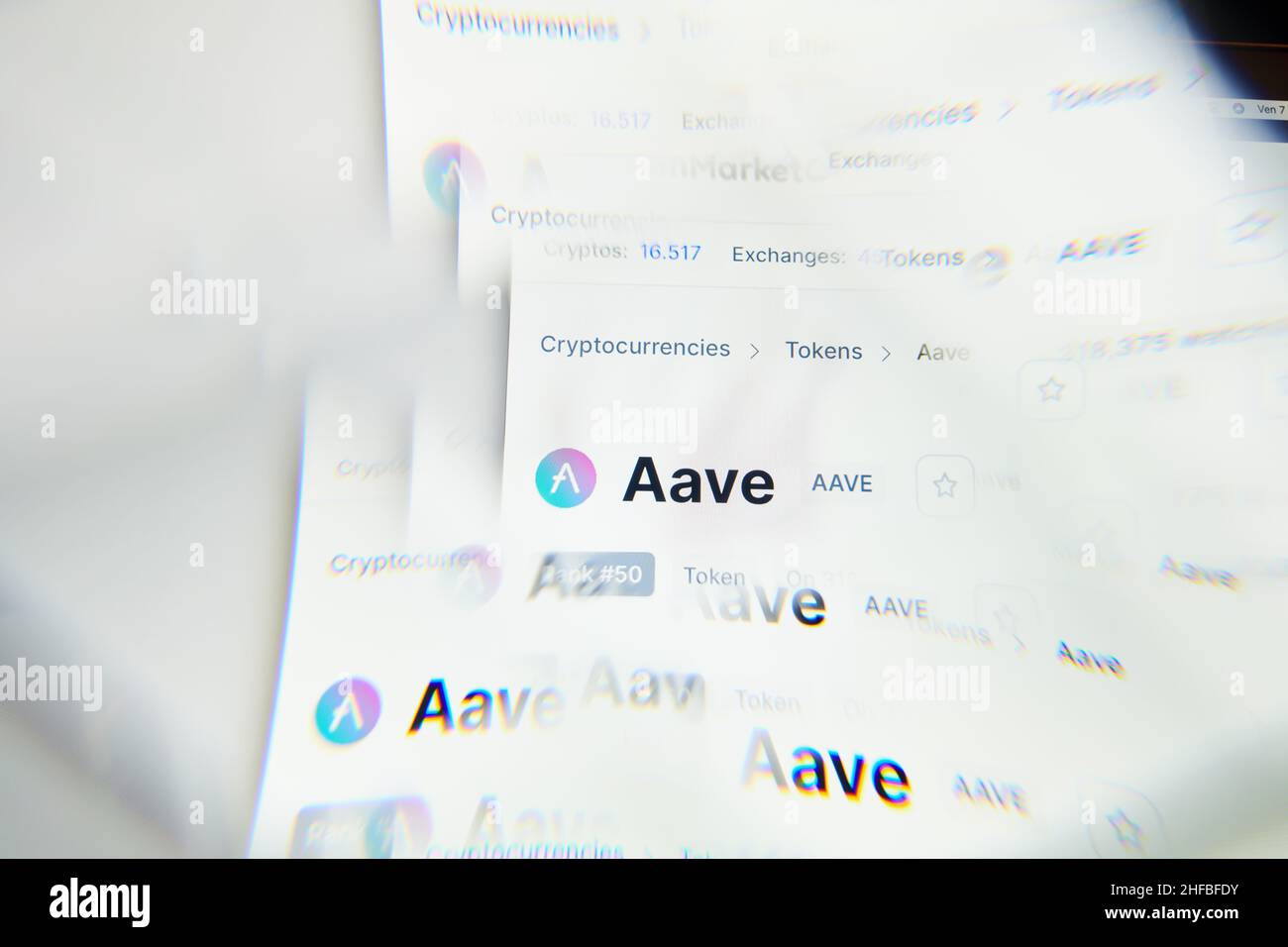 Milan, Italy - January 11, 2022: aave - AAVE logo on laptop screen seen through an optical prism. Dynamic and unique image form aave, AAVE coin websit Stock Photo