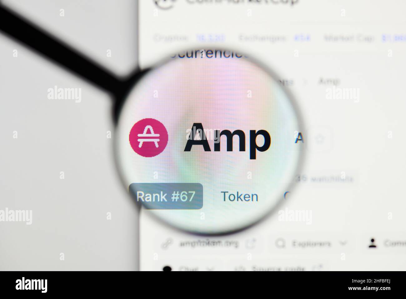 Milan, Italy - January 11, 2022: amp - AMP website's hp.  amp, AMP coin logo visible through a loope. Defi, ntf, cryptocurrency concepts illustrative Stock Photo