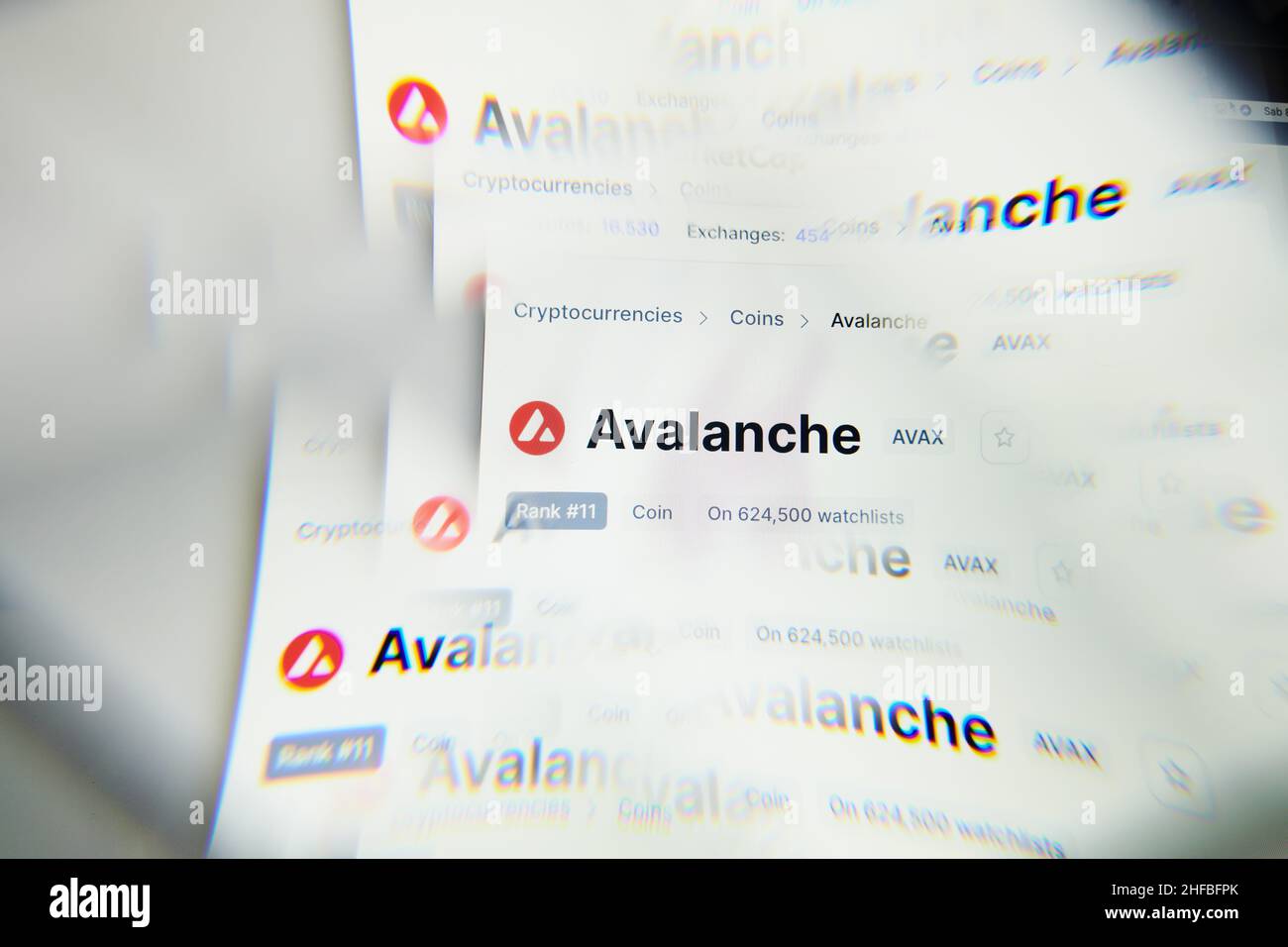 Milan, Italy - January 11, 2022: avalanche - AVAX logo on laptop screen seen through an optical prism. Dynamic and unique image form avalanche, AVAX c Stock Photo