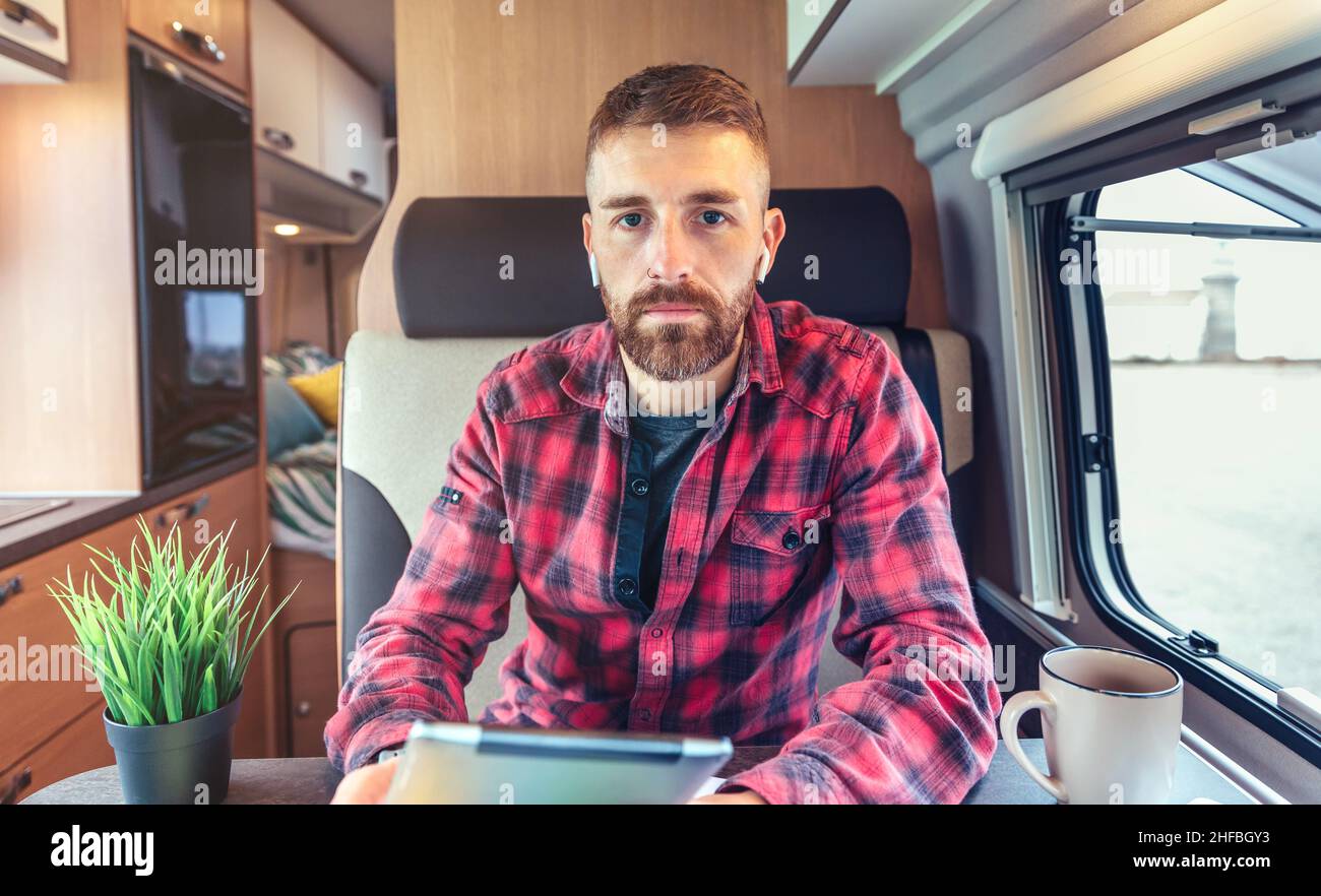 Man on video call from his campervan Stock Photo