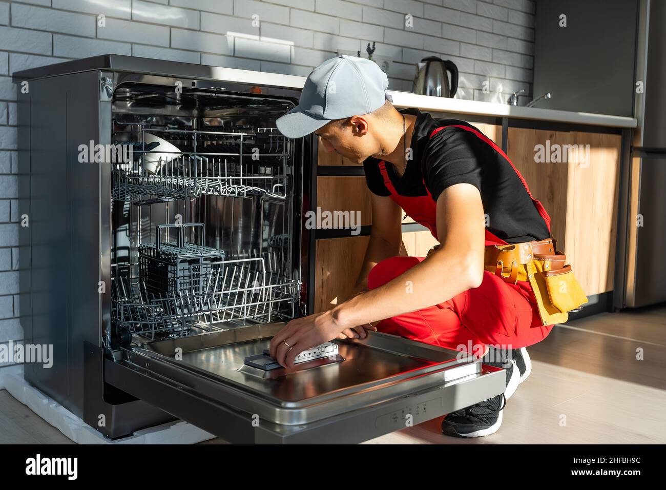 Master installing the dishwasher in a kitchen Stock Photo Alamy