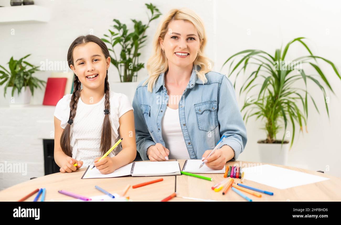 Mother and daughter spending time together at home drawing Stock Photo ...