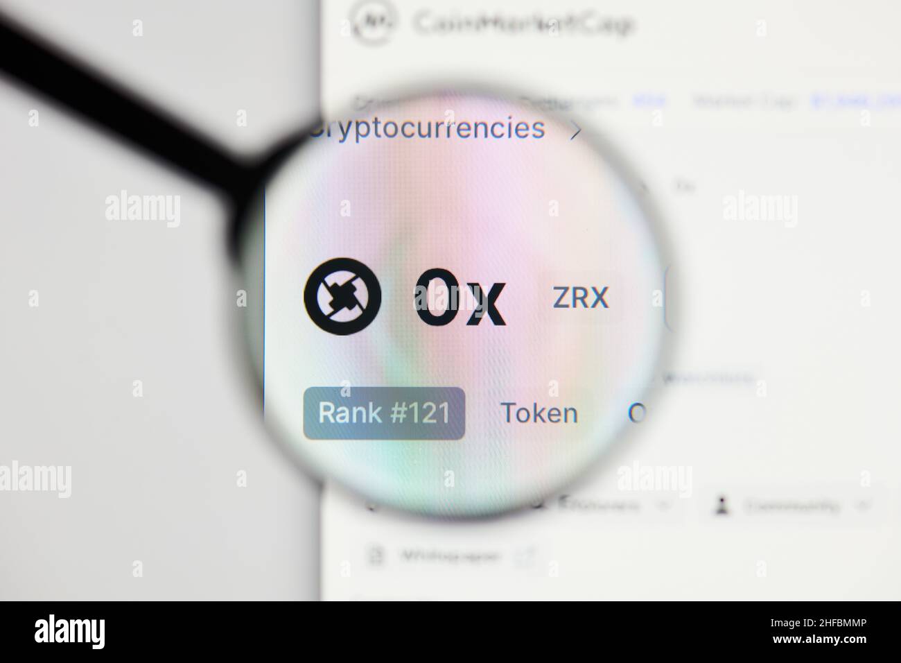 Milan, Italy - January 11, 2022: 0x - ZRX website's hp.  0x, ZRX coin logo visible through a loope. Defi, ntf, cryptocurrency concepts illustrative ed Stock Photo