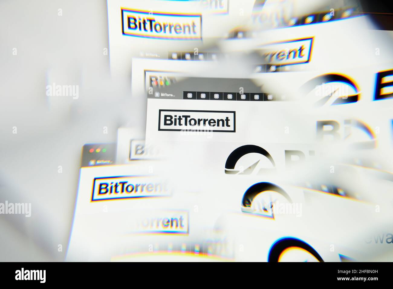 Milan, Italy - January 11, 2022: bittorrent - BTT logo on laptop screen seen through an optical prism. Dynamic and unique image form bittorrent, BTT c Stock Photo