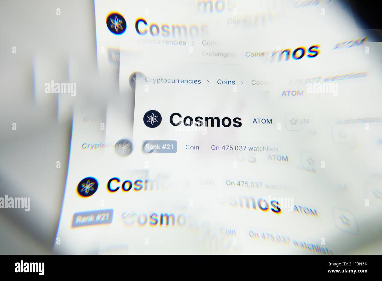 Milan, Italy - January 11, 2022: cosmos - ATOM logo on laptop screen seen through an optical prism. Dynamic and unique image form cosmos, ATOM coin we Stock Photo