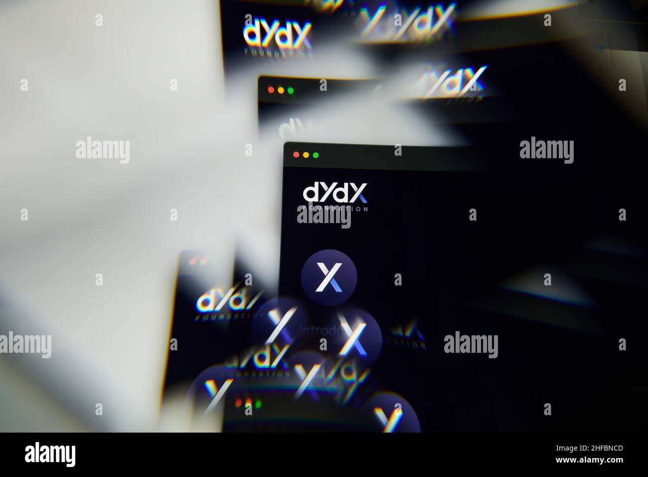 Milan, Italy - January 11, 2022: dydx - DYDX logo on laptop screen seen through an optical prism. Dynamic and unique image form dydx, DYDX coin websit Stock Photo