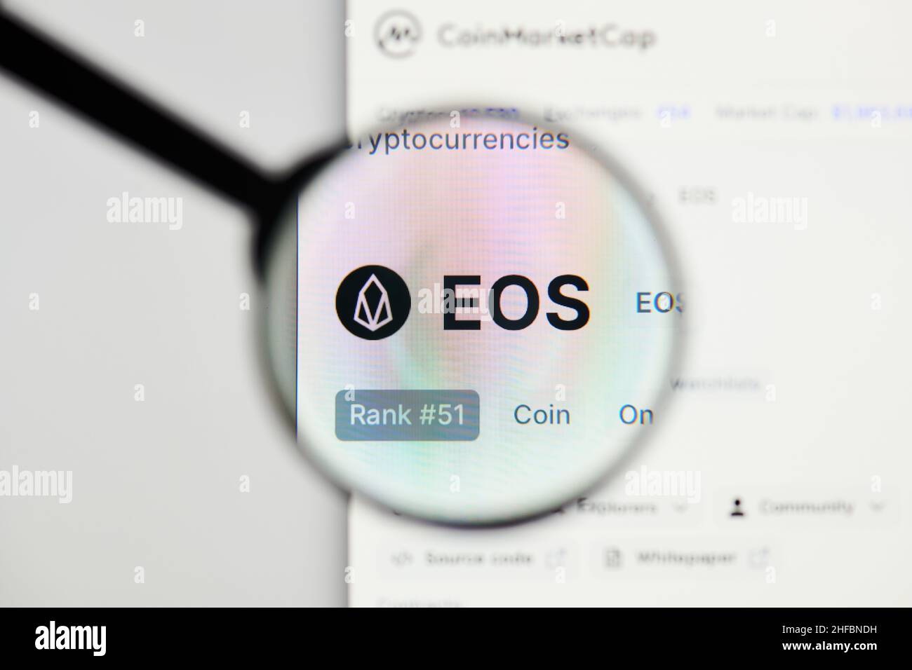 Milan, Italy - January 11, 2022: eos - EOS website's hp.  eos, EOS coin logo visible through a loope. Defi, ntf, cryptocurrency concepts illustrative Stock Photo