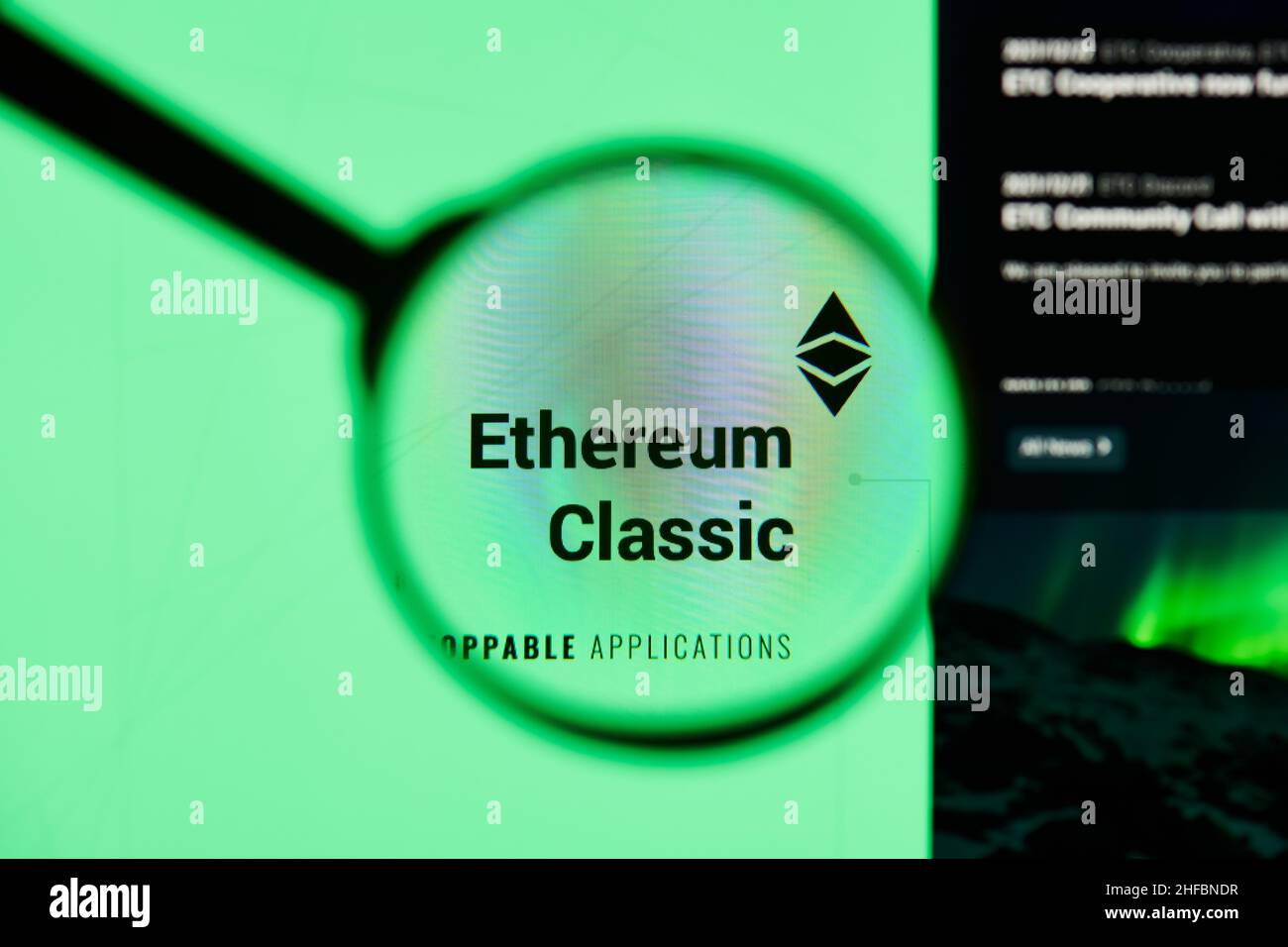 Milan, Italy - January 11, 2022: ethereum classic - ETC website's hp.  ethereum classic, ETC coin logo visible through a loope. Defi, ntf, cryptocurre Stock Photo