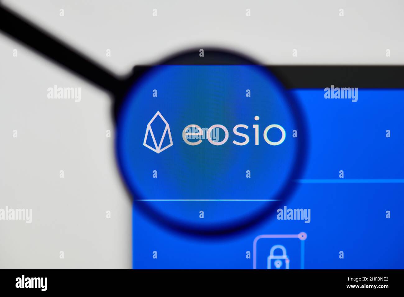 Milan, Italy - January 11, 2022: eos - EOS website's hp.  eos, EOS coin logo visible through a loope. Defi, ntf, cryptocurrency concepts illustrative Stock Photo