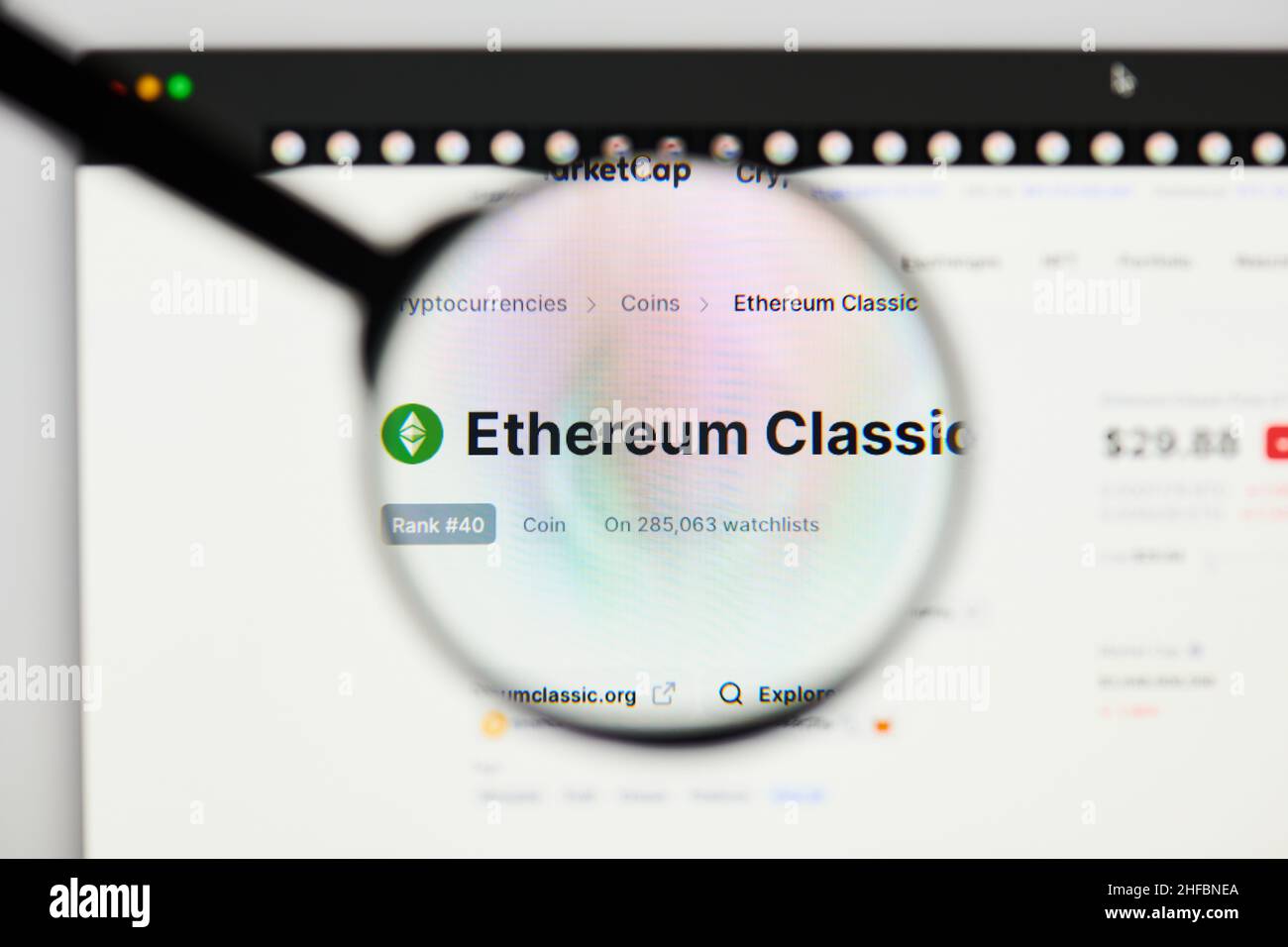 Milan, Italy - January 11, 2022: ethereum classic - ETC website's hp.  ethereum classic, ETC coin logo visible through a loope. Defi, ntf, cryptocurre Stock Photo