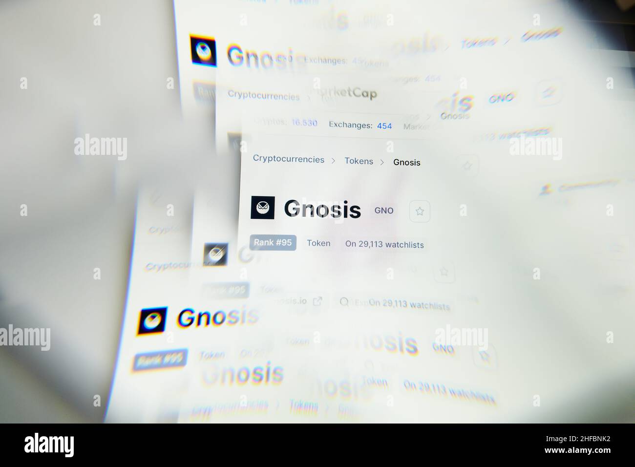 Milan, Italy - January 11, 2022: gnosis - GNO logo on laptop screen seen through an optical prism. Dynamic and unique image form gnosis, GNO coin webs Stock Photo