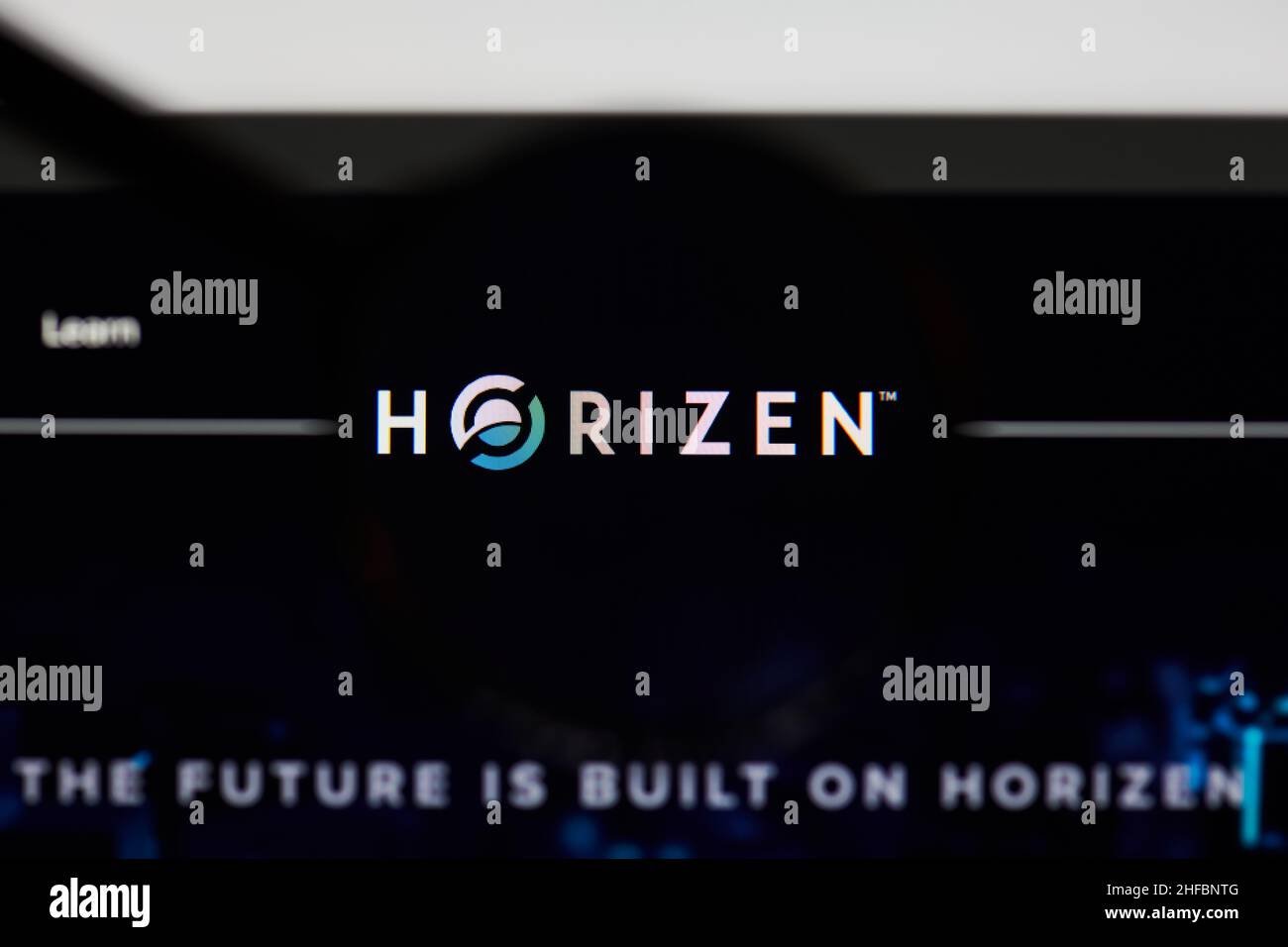 Milan, Italy - January 11, 2022: horizen - ZEN website's hp.  horizen, ZEN coin logo visible through a loope. Defi, ntf, cryptocurrency concepts illus Stock Photo