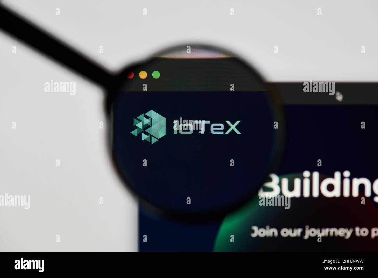 Milan, Italy - January 11, 2022: iotex - IOTX website's hp.  iotex, IOTX coin logo visible through a loope. Defi, ntf, cryptocurrency concepts illustr Stock Photo