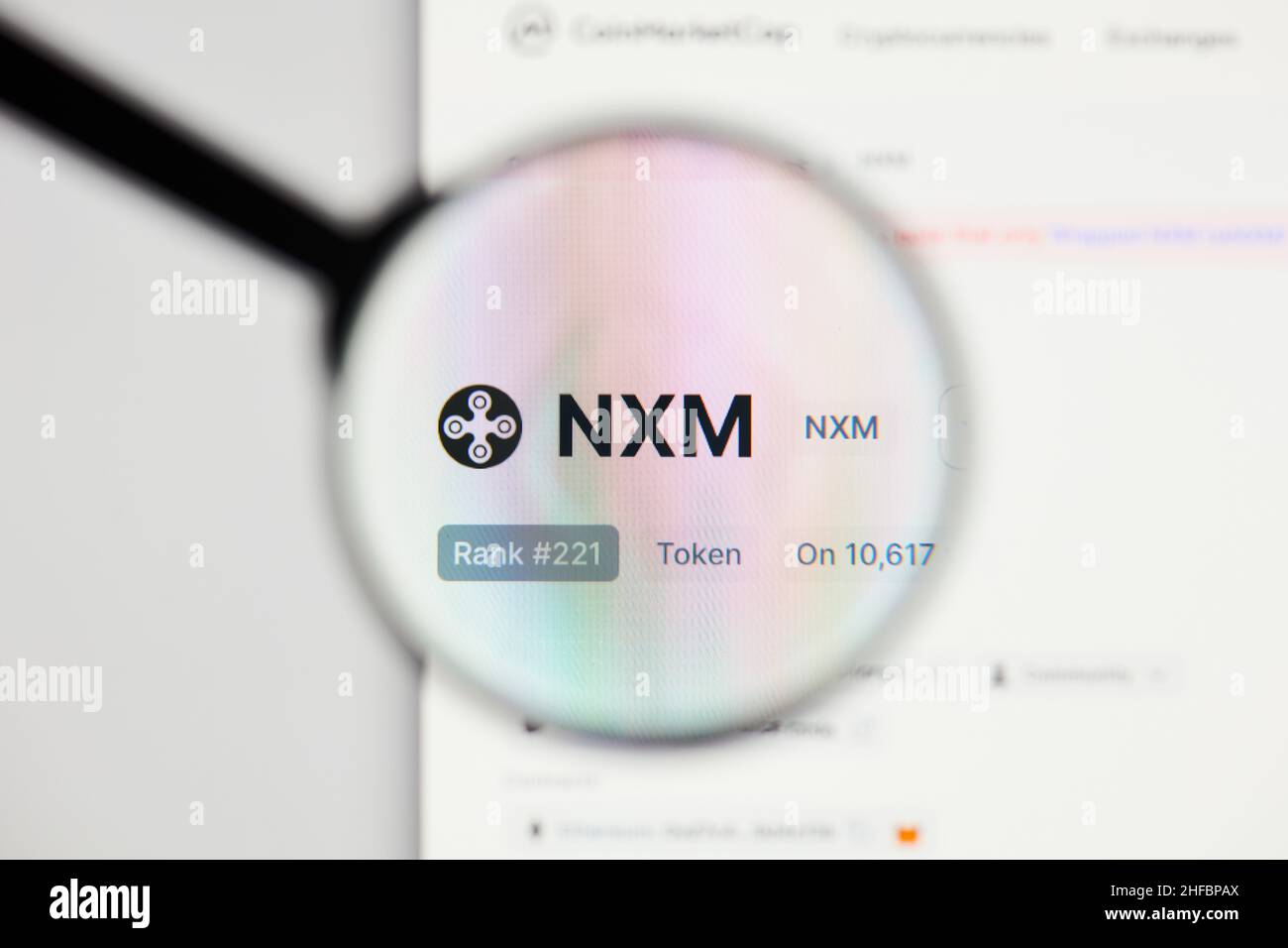 Milan, Italy - January 11, 2022: nexus mutual - NXM website's hp.  nexus mutual, NXM coin logo visible through a loope. Defi, ntf, cryptocurrency conc Stock Photo
