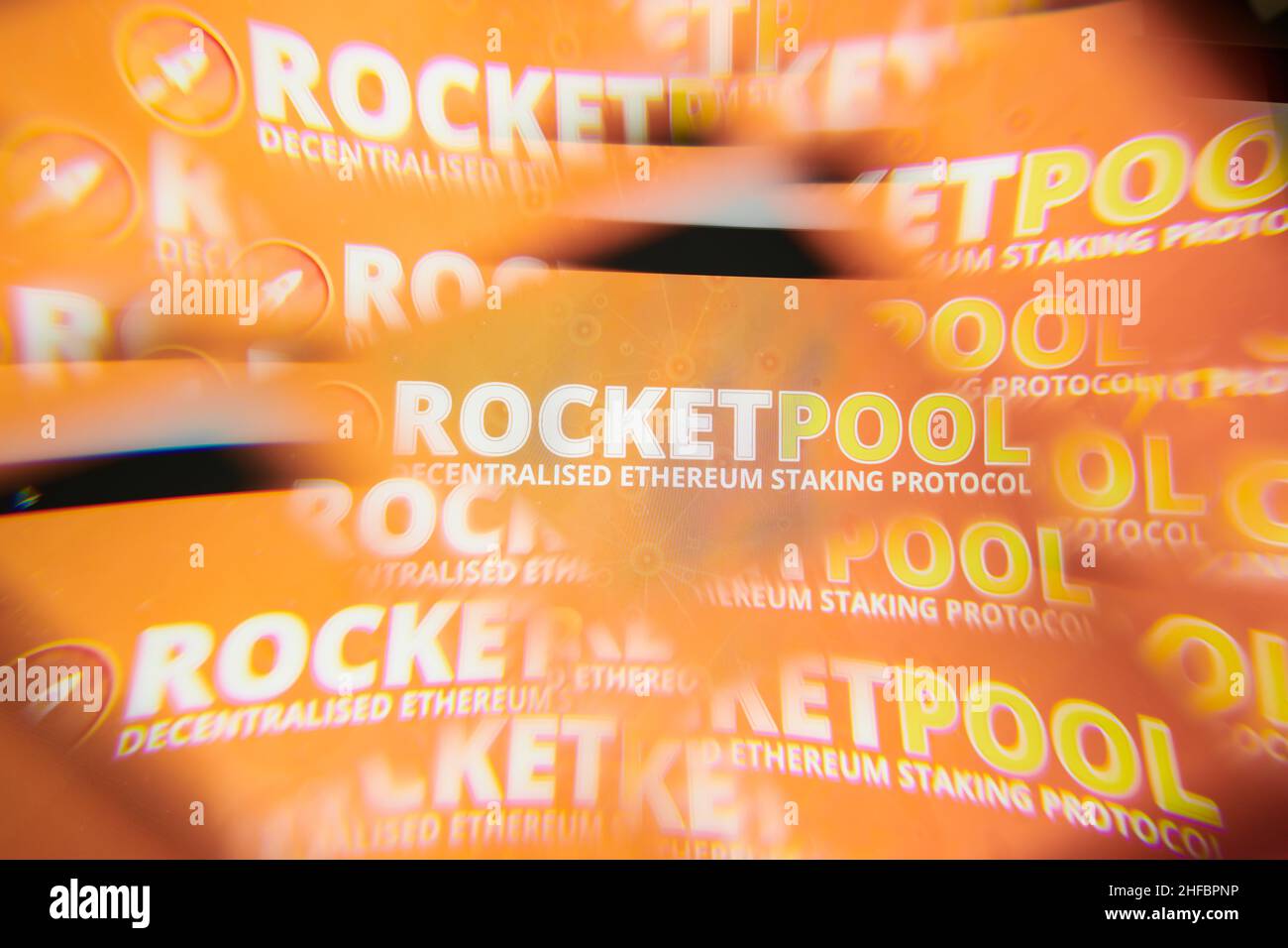Milan, Italy - January 11, 2022: rocket pool - RPL logo on laptop screen seen through an optical prism. Dynamic and unique image form rocket pool, RPL Stock Photo
