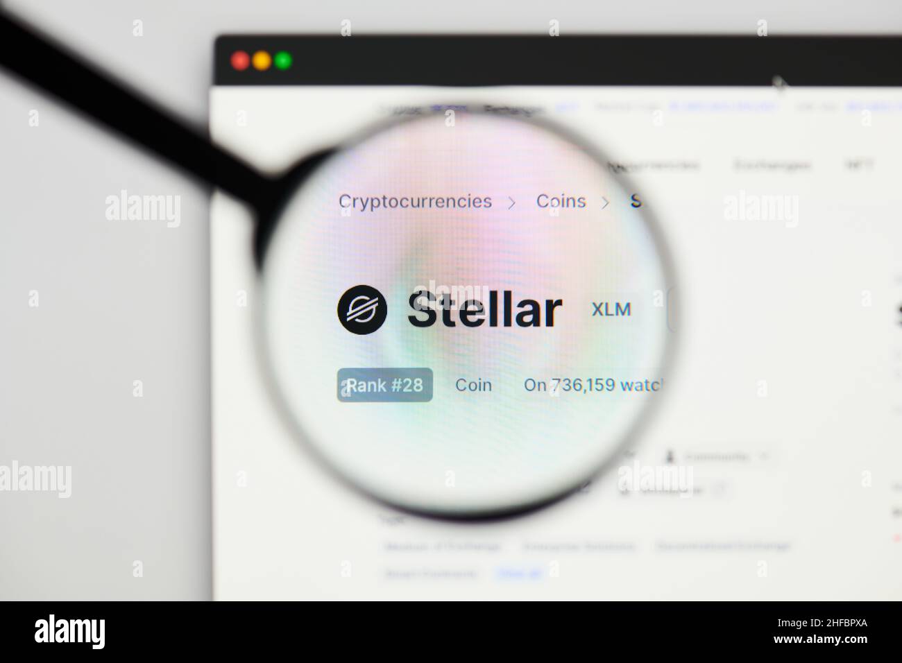 Milan, Italy - January 11, 2022: stellar - XLM website's hp.  stellar, XLM coin logo visible through a loope. Defi, ntf, cryptocurrency concepts illus Stock Photo