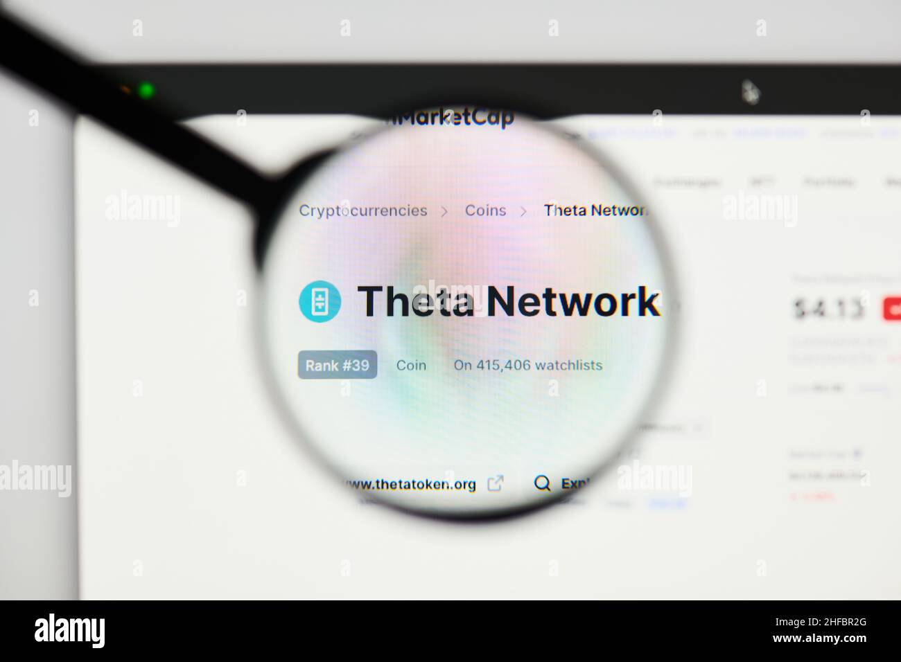 Milan, Italy - January 11, 2022: theta network - THETA website's hp.  theta network, THETA coin logo visible through a loope. Defi, ntf, cryptocurrenc Stock Photo
