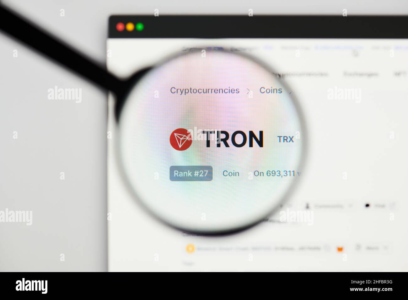 Milan, Italy - January 11, 2022: tron - TRX website's hp.  tron, TRX coin logo visible through a loope. Defi, ntf, cryptocurrency concepts illustrativ Stock Photo