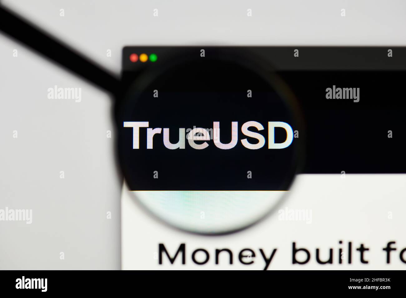 Milan, Italy - January 11, 2022: trueusd - TUSD website's hp.  trueusd, TUSD coin logo visible through a loope. Defi, ntf, cryptocurrency concepts ill Stock Photo