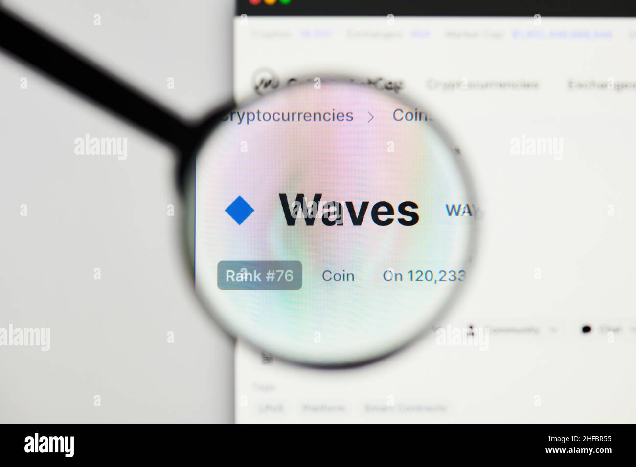 Milan, Italy - January 11, 2022: waves - WAVES website's hp.  waves, WAVES coin logo visible through a loope. Defi, ntf, cryptocurrency concepts illus Stock Photo