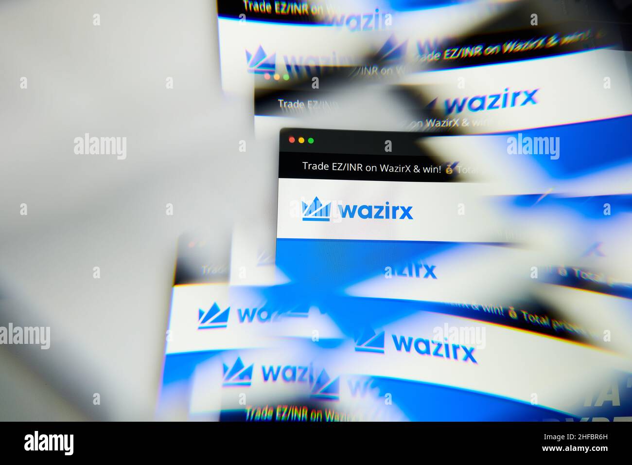 Milan, Italy - January 11, 2022: wazirx - WRX logo on laptop screen seen through an optical prism. Dynamic and unique image form wazirx, WRX coin webs Stock Photo