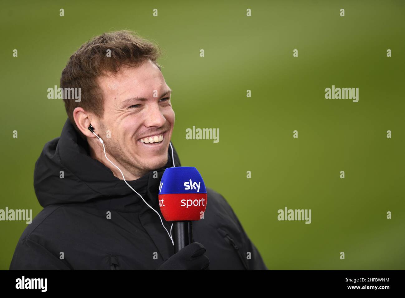 Cologne, Germany. 15th Jan, 2022. Soccer: Bundesliga, 1. FC Köln - FC  Bayern München, Matchday 19, RheinEnergieStadion. Munich coach Julian  Nagelsmann smiles during an interview with Sky before the match.IMPORTANT  NOTE: In