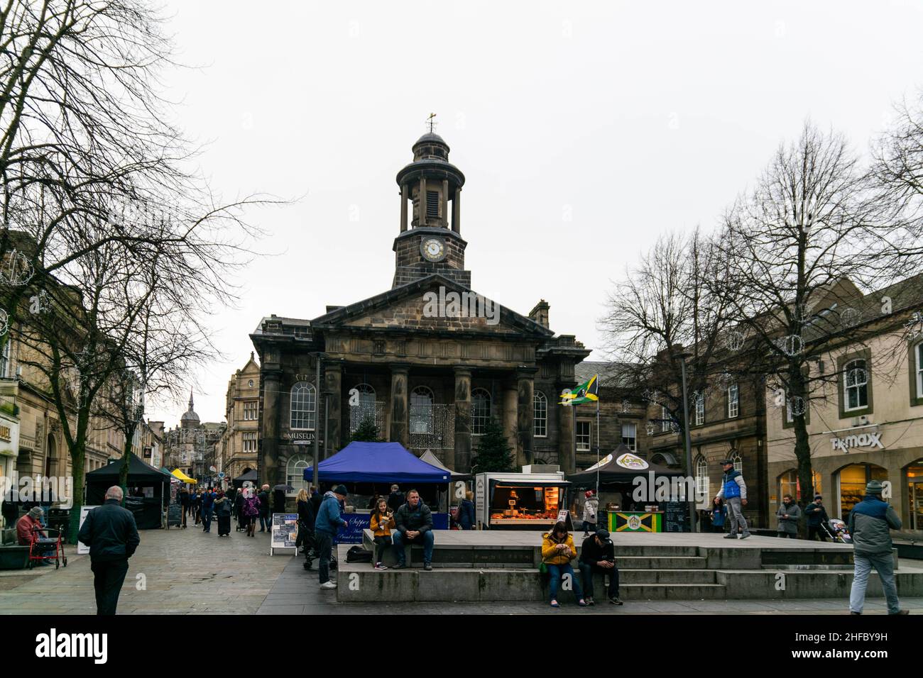 Lancaster, UK - 4th January 2020: Lancaster City Museum in the busy Market Square, Lancaster. People enjoy the fresh food market, shopping in the high Stock Photo