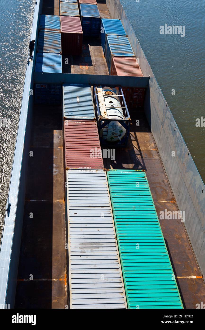ship on river transports container in belly Stock Photo