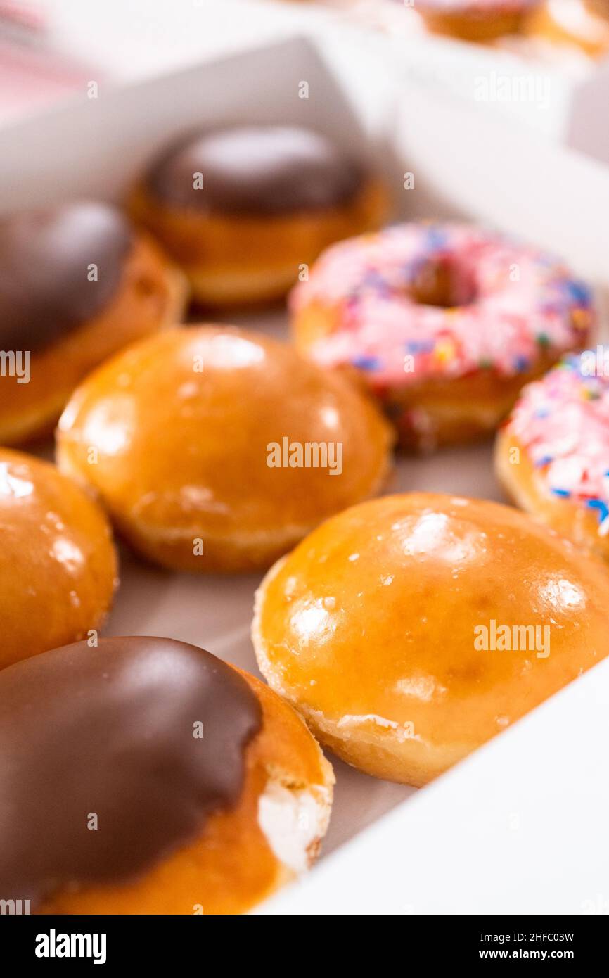 Variety of storebought doughnuts in a white paper box Stock Photo Alamy