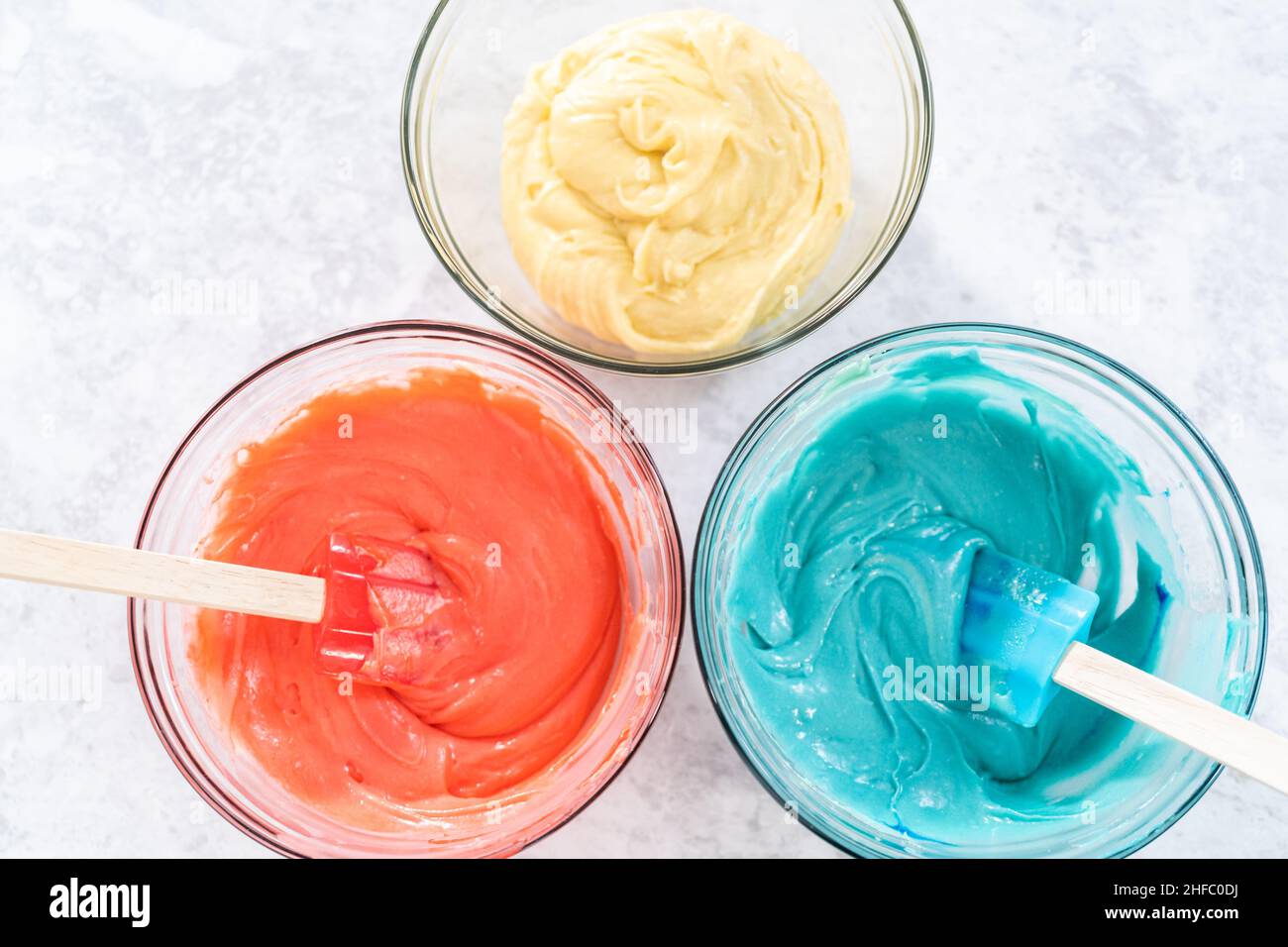 Mixing red and blue food coloring into the cake dough Stock Photo Alamy