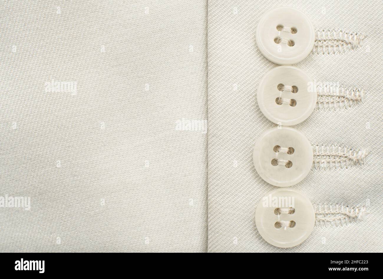 Buttons on white clothes. Element of men's clothing. Sleeve with buttons men's suit Stock Photo