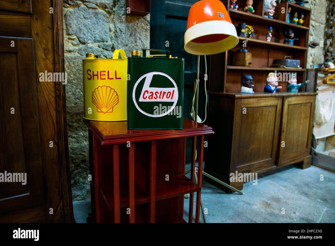 Porto, Portugal - 18 Nov 2020: Old vintage Shell and Castrol petroleum oil canisters on a wooden table in a home. Retro old school home décor. Retro l Stock Photo