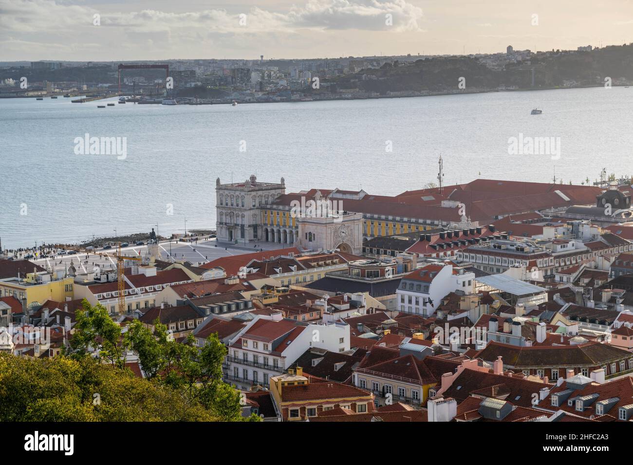 Beautiful cityscape view over Lisbon, Portugal, including orange rooftops, river Douro and Rua Augusta Arch - a stone triumphal arch in Praça do Comér Stock Photo