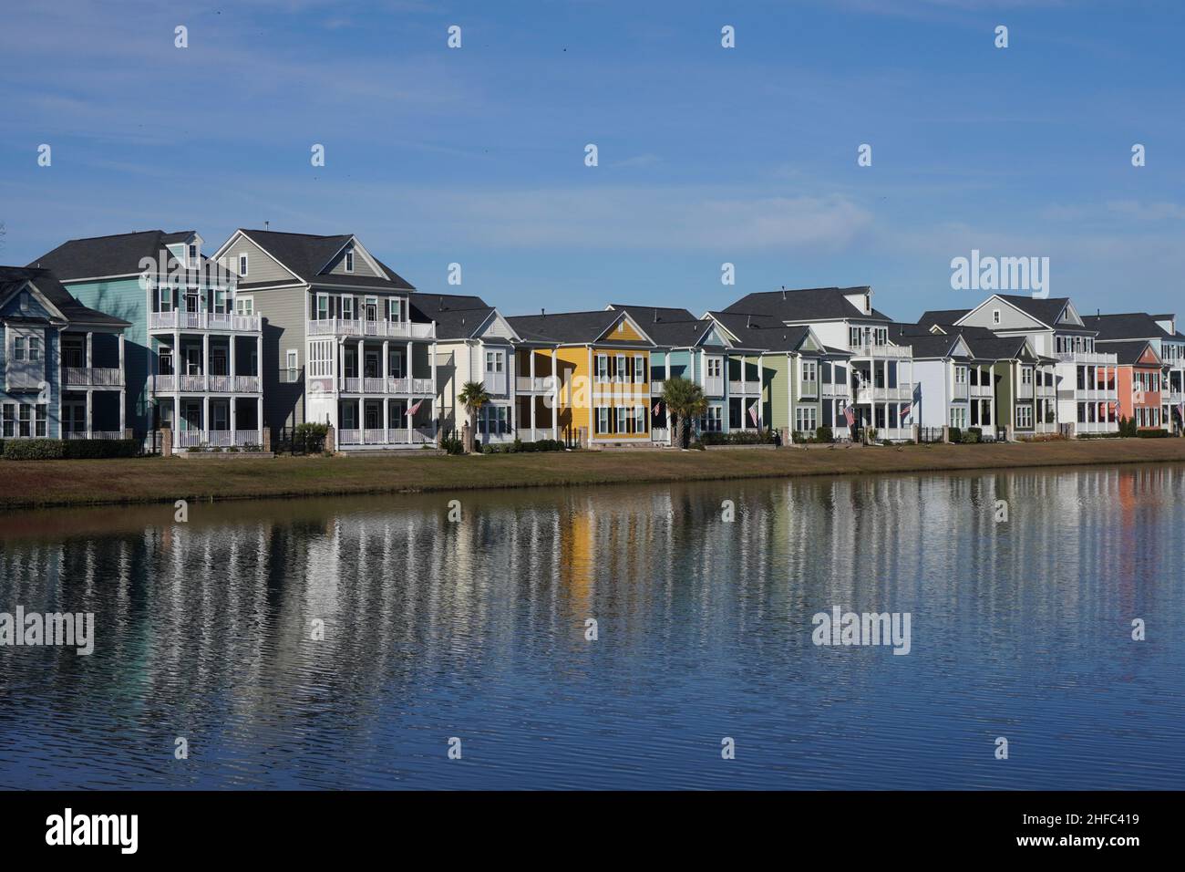 Row of Colorful Houses Reflecting in a Pond in a Surban Neighborhood. in South Carolina. Stock Photo