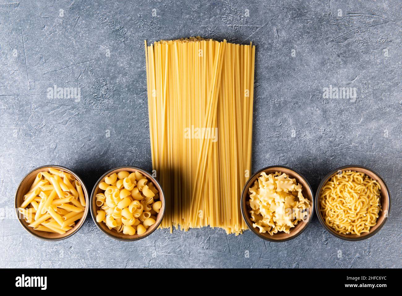 Different types of pasta on stone background Stock Photo