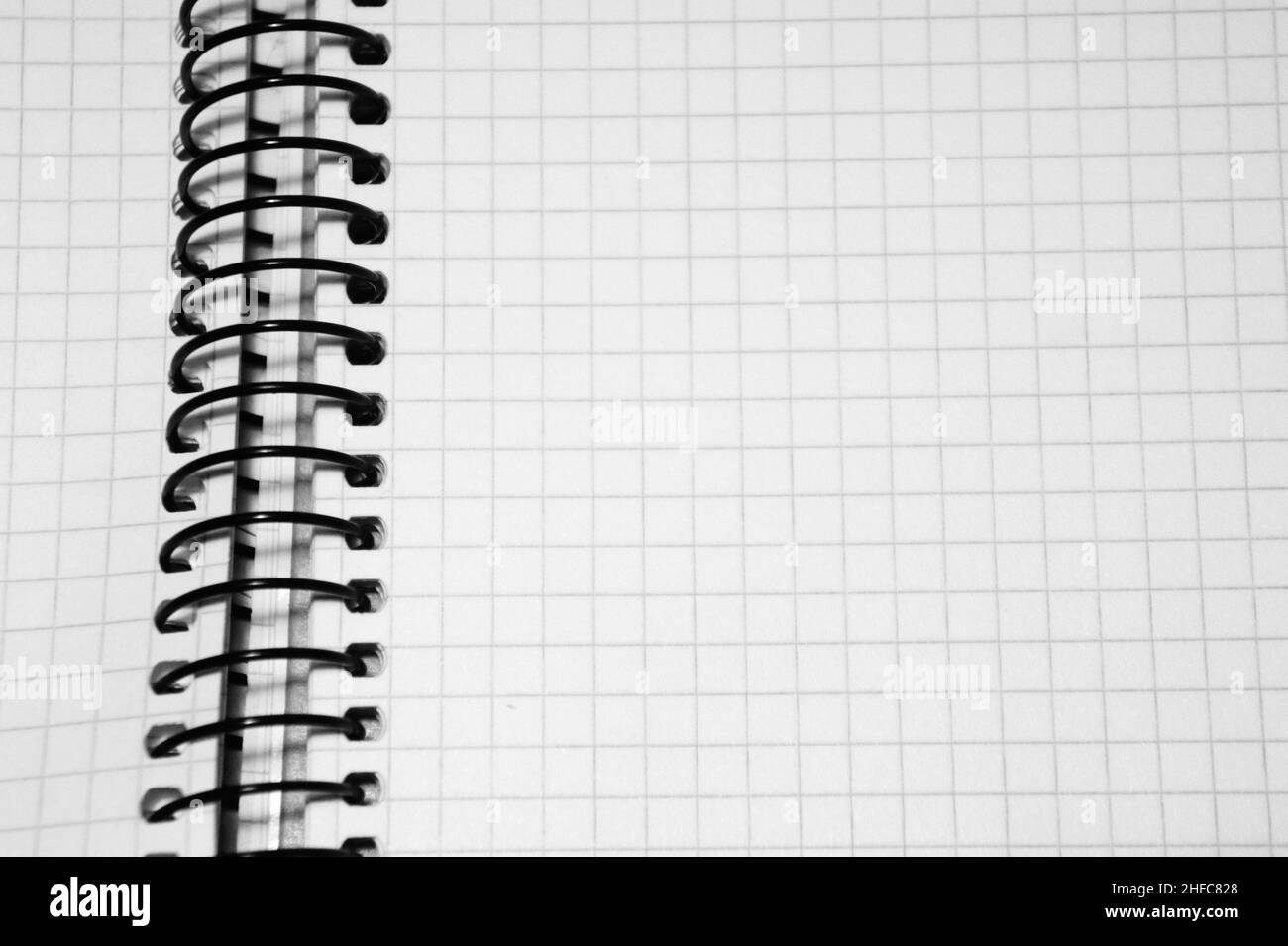 notepad in the cage, on the spring black and white Stock Photo