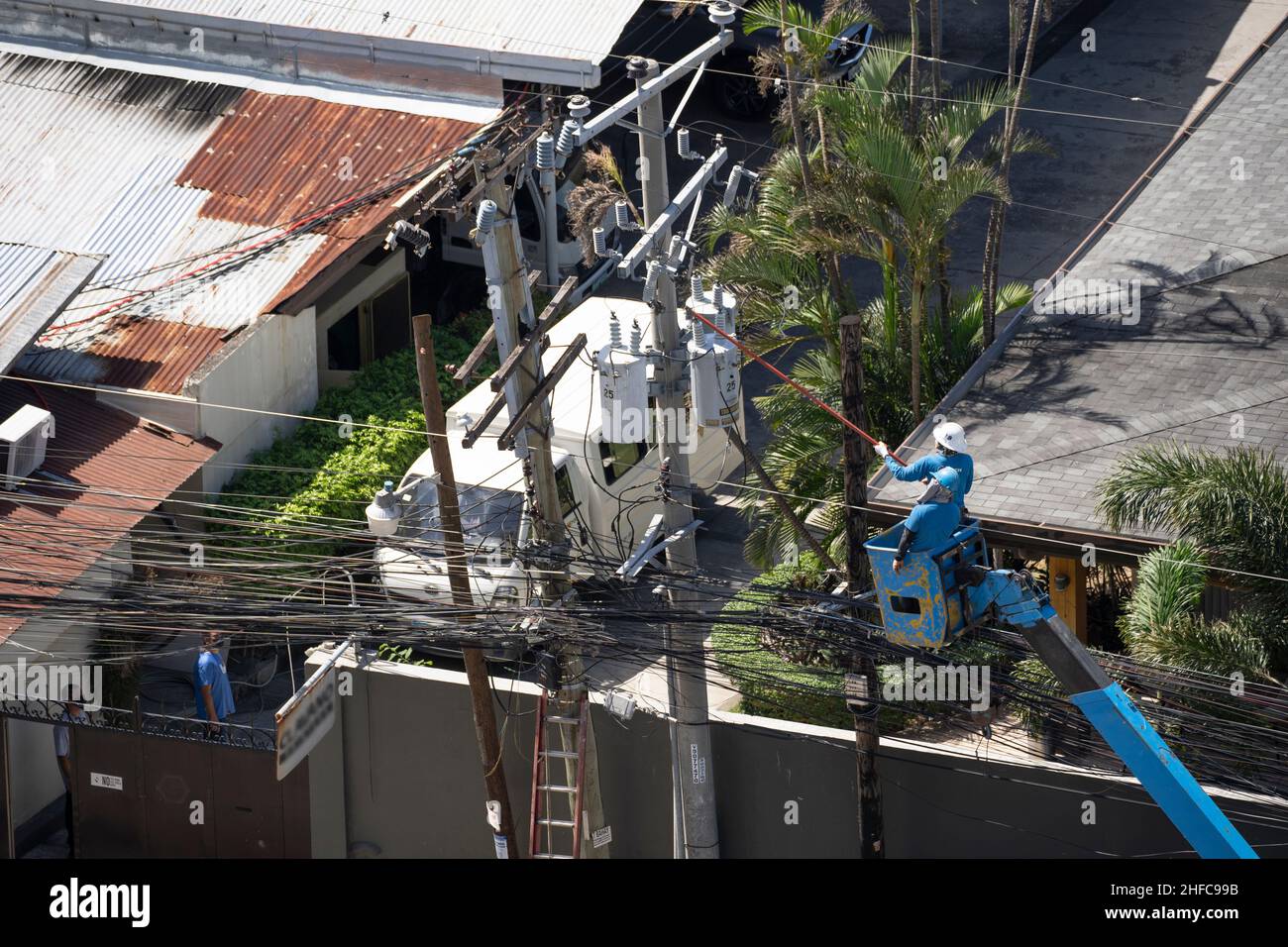 Electricians restoring mains electricity supply after disruption by Typhoon Odette, Cebu City, Philippines Stock Photo
