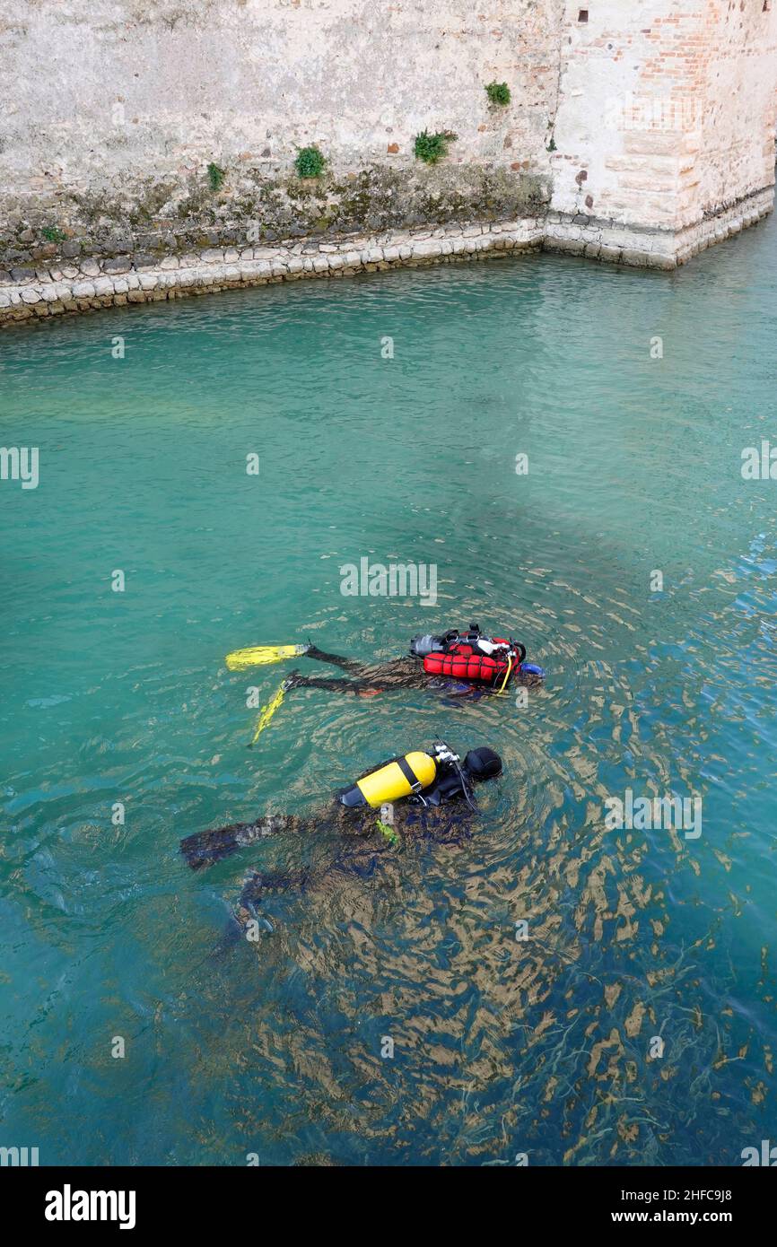 Scuba divers workers underwater archaeology works. Lake underwater