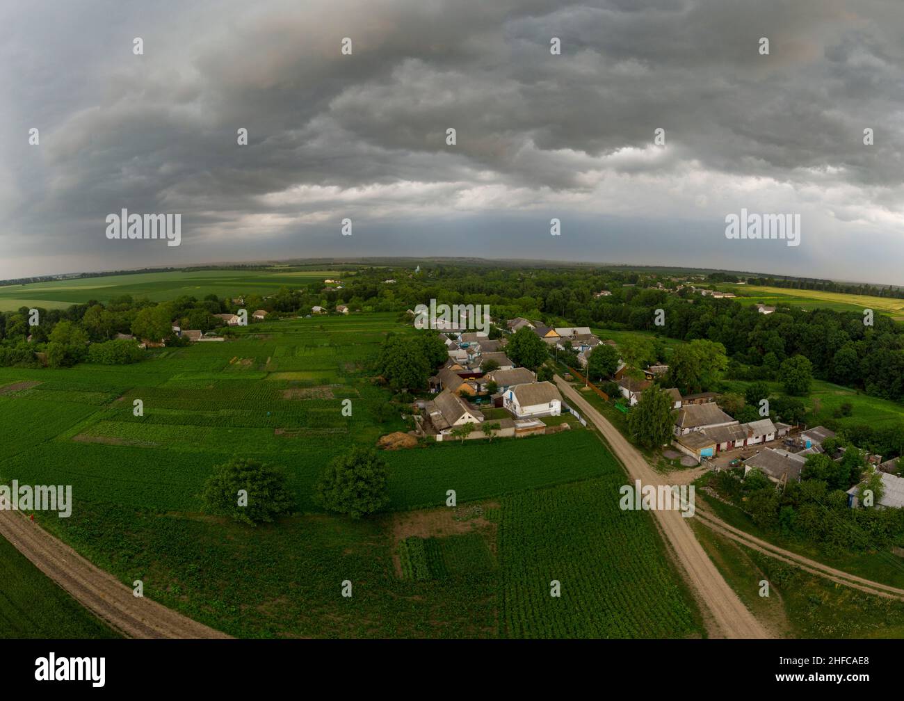 Storm clouds over village houses Stock Photo - Alamy