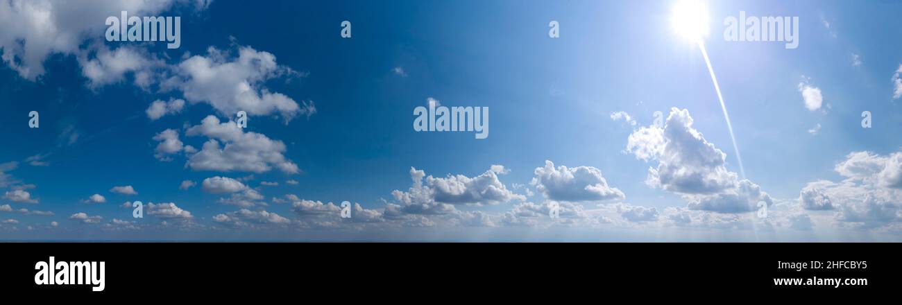 panorama of blue sky with clouds and sun Stock Photo - Alamy