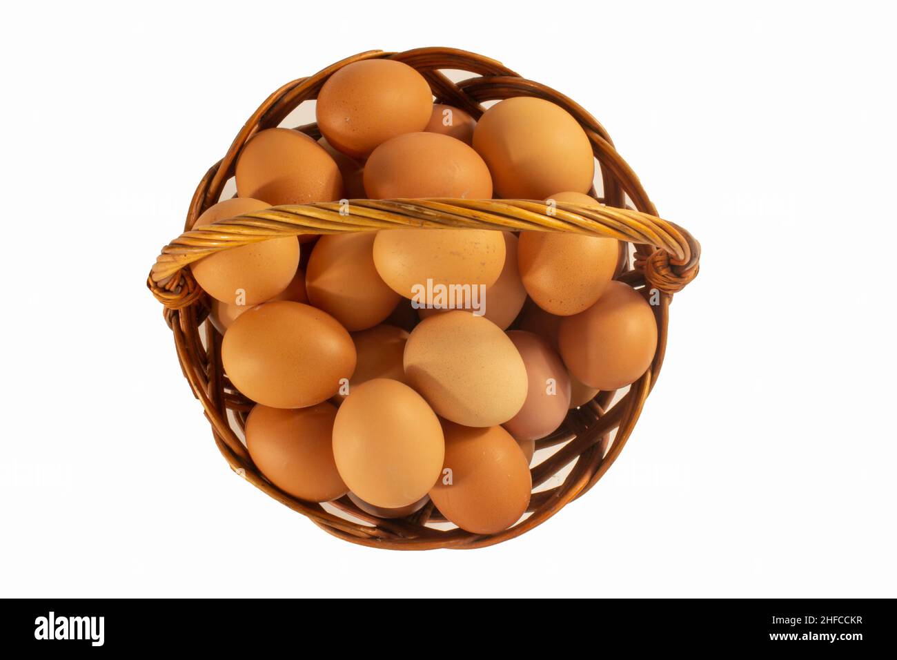 Chicken eggs in basket isolated on white Stock Photo