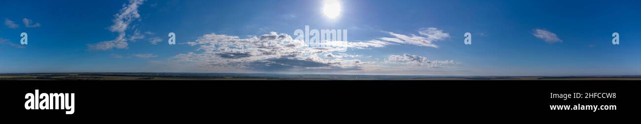 Panorama of the sky. Fluffy clouds with the sun. Stock Photo